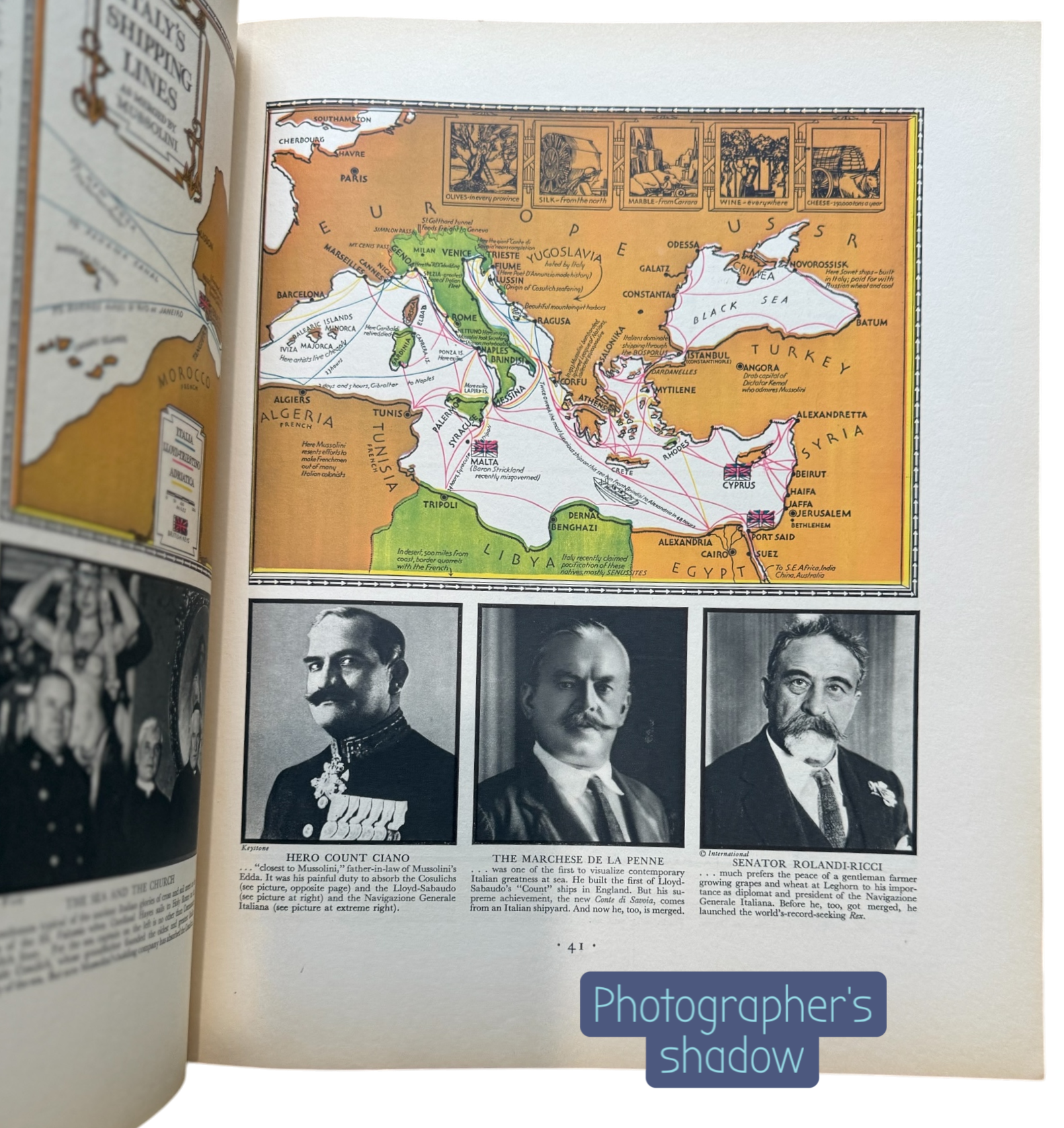 Open book with historical content including a map and black-and-white photos of men.
